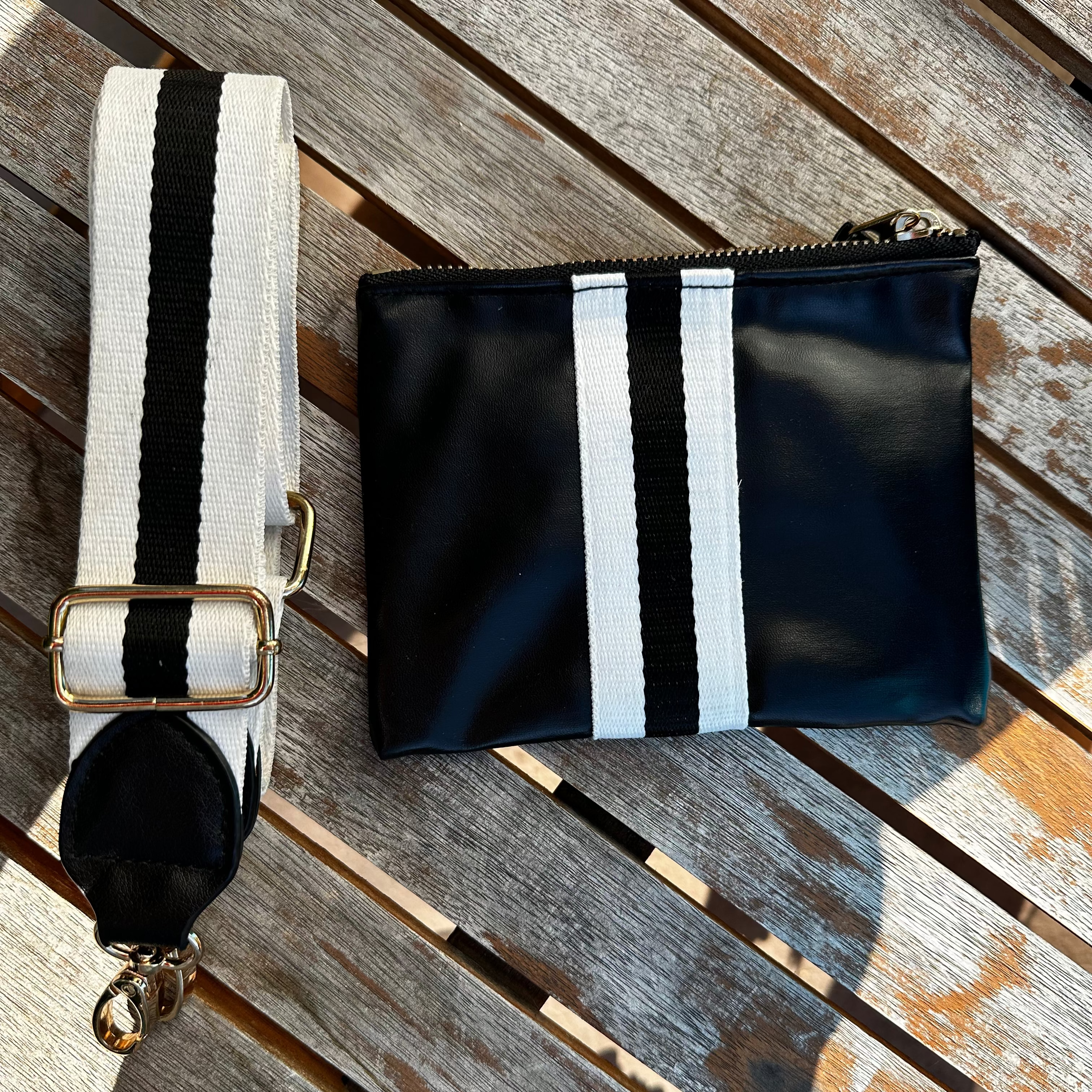 Faux-leather black accessories pouch with matching black and white striped purse strap