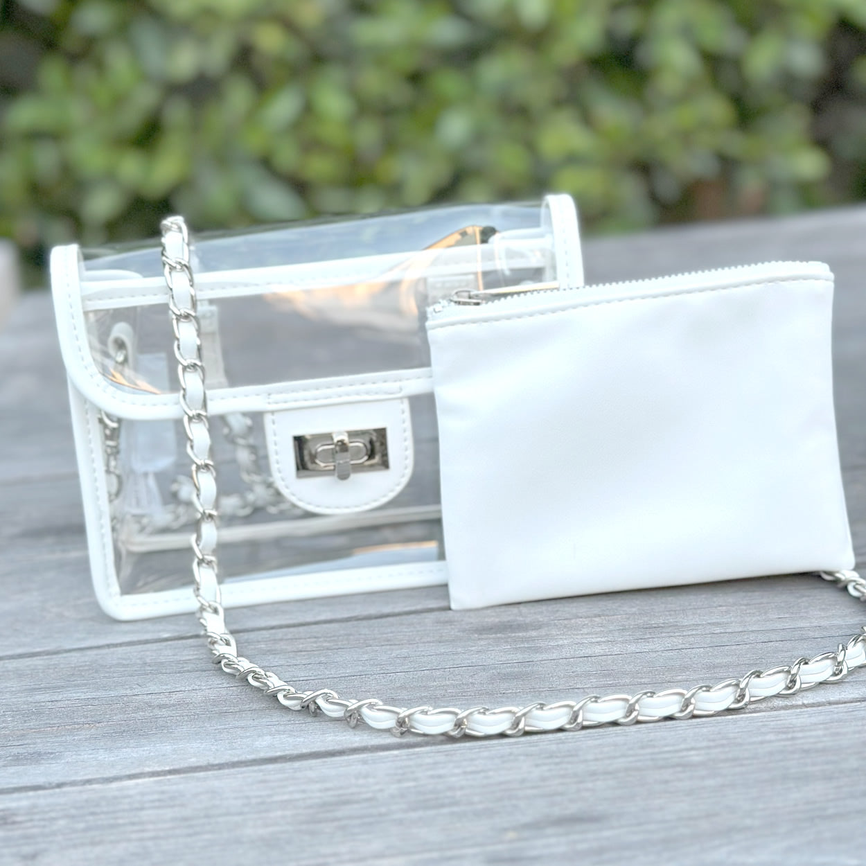 Clear, stadium approved white purse with a silver chain