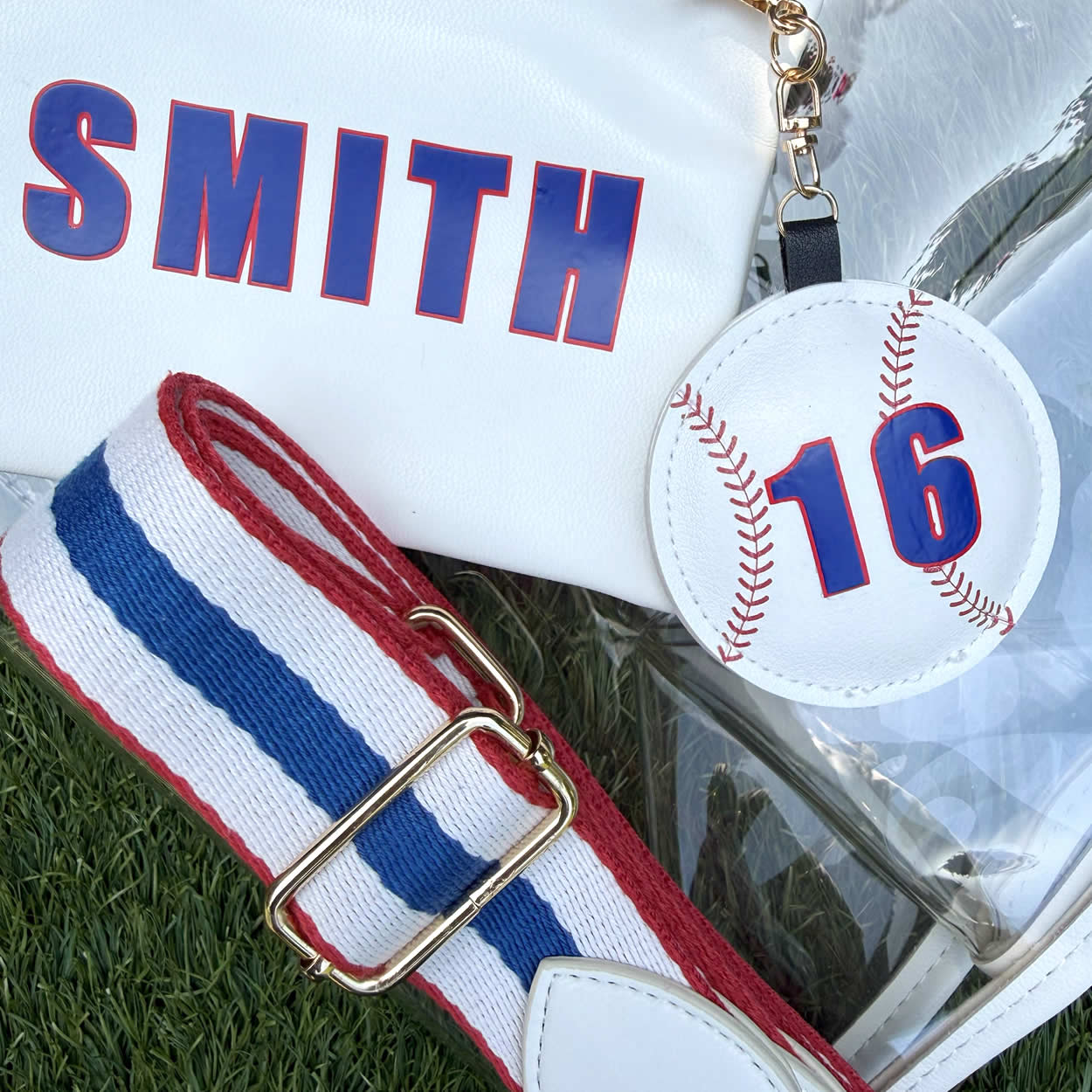 Baseball-themed purse accessory with number '16' next to matching Sheergear pouch and red, white, blue striped purse strap