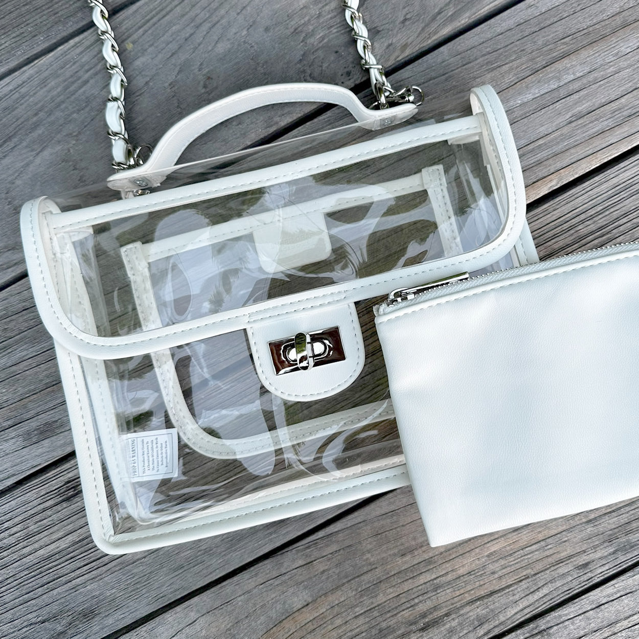 Clear, stadium-approved white purse with a silver chain