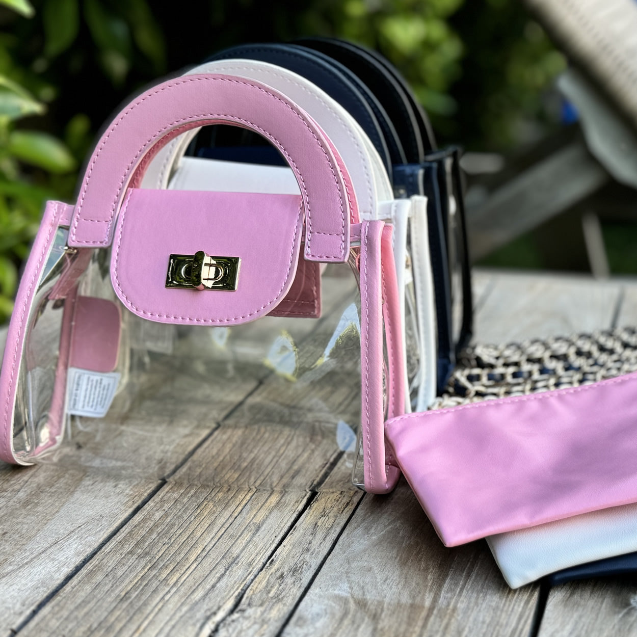 clear, stadium-approved fashion purses with faux-leather trim in a variety of colors