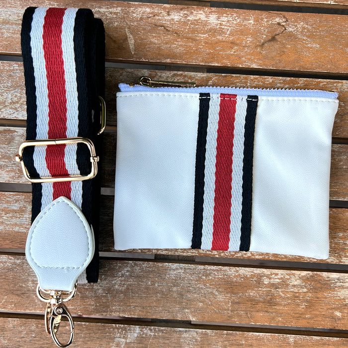 Faux-leather white accessories pouch with matching red, white, and black striped purse strap