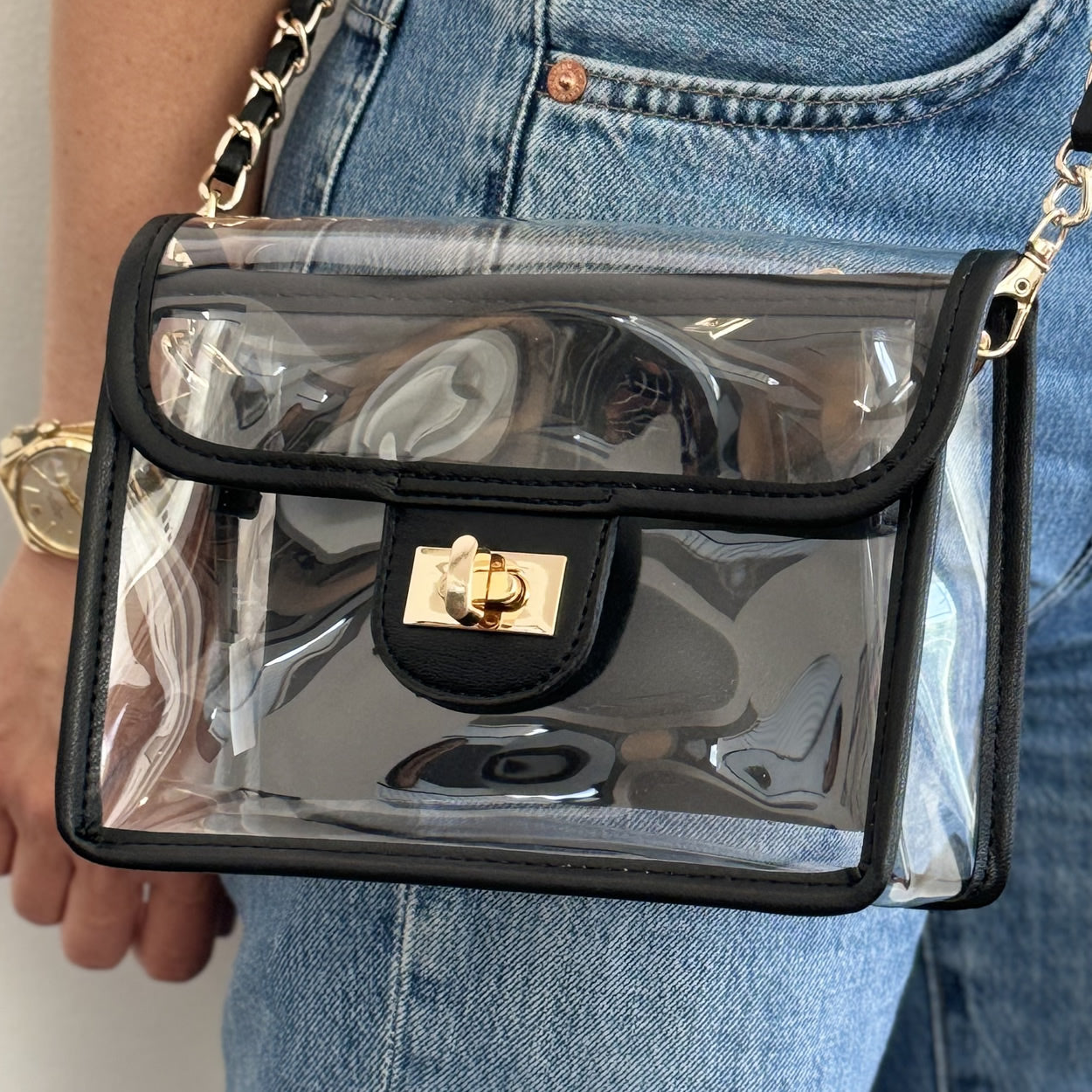 Clear, stadium approved black faux-leather trim purse with a gold chain