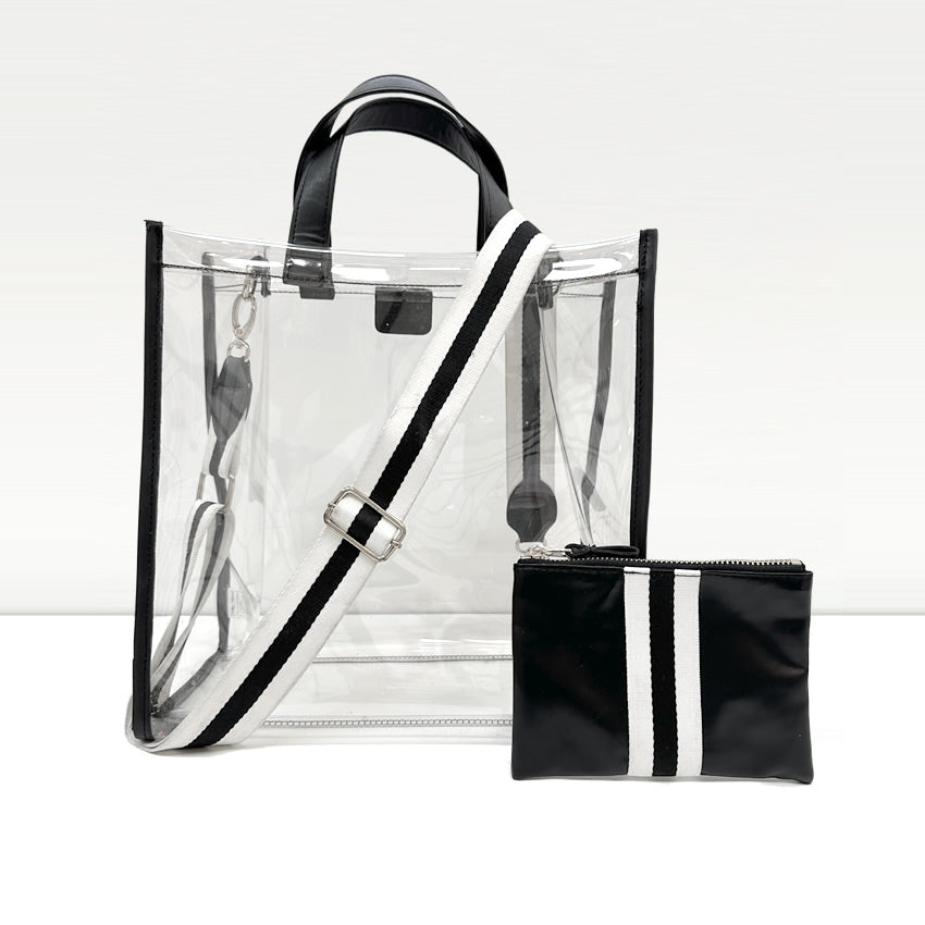 A clear, stadium compliant tote bag with sporty black and white striped handles and trim.