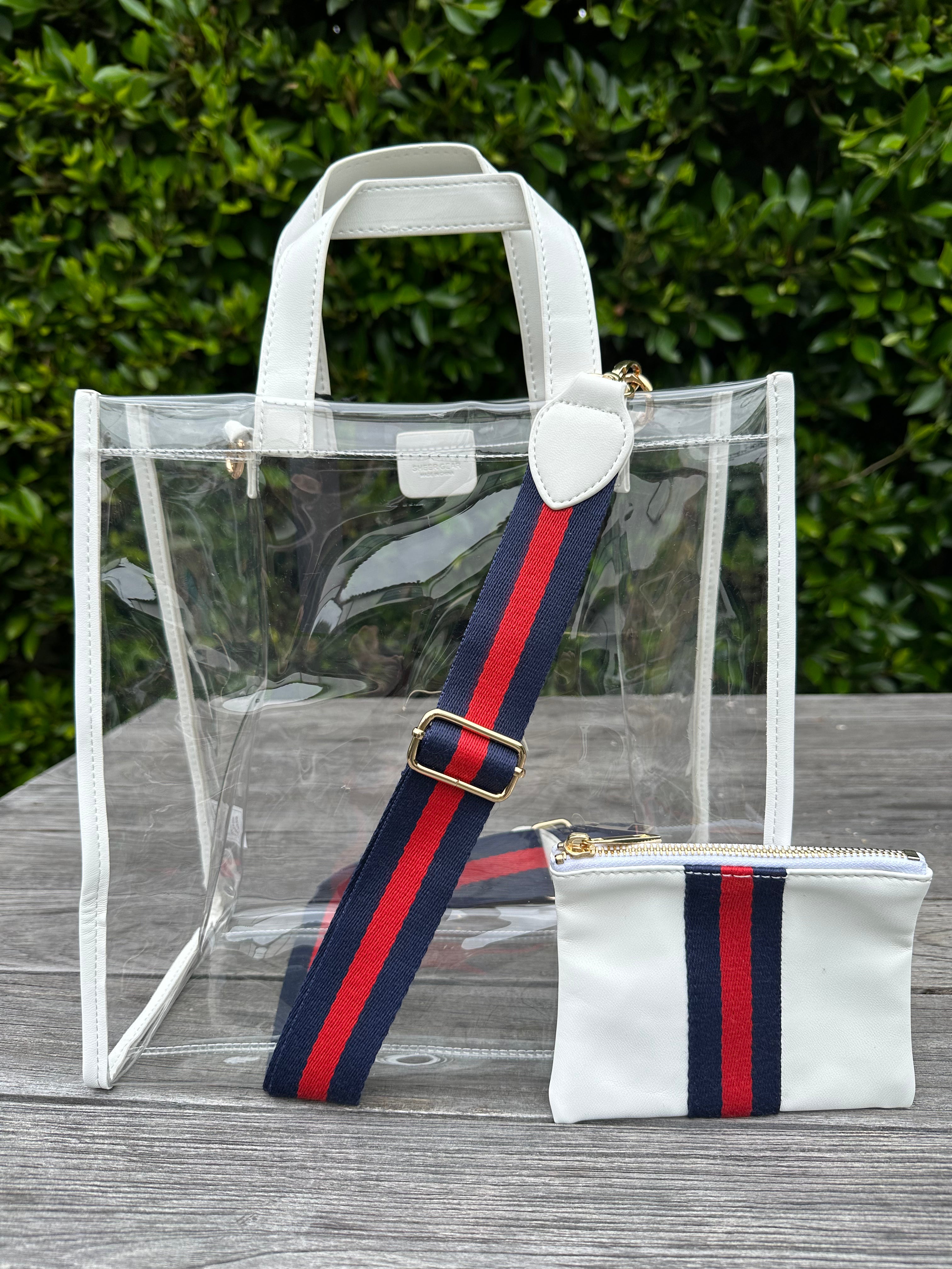 Stadium approved, clear tote back with a navy and red sporty stripe strap and matching accessory pouch