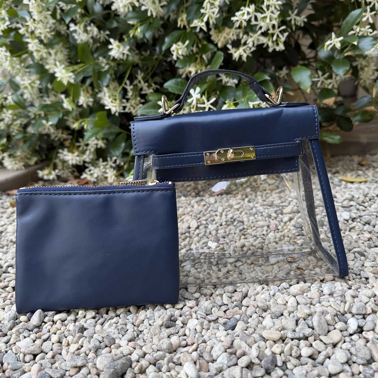 Elegant, navy stadium-approved purse with gold lock , top handle, and clear sides.