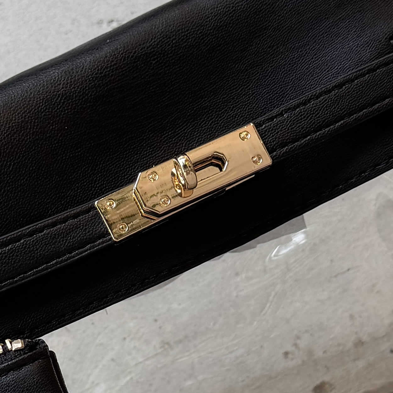 Close up of the turn-lock closure on a black-trim, gameday bag 