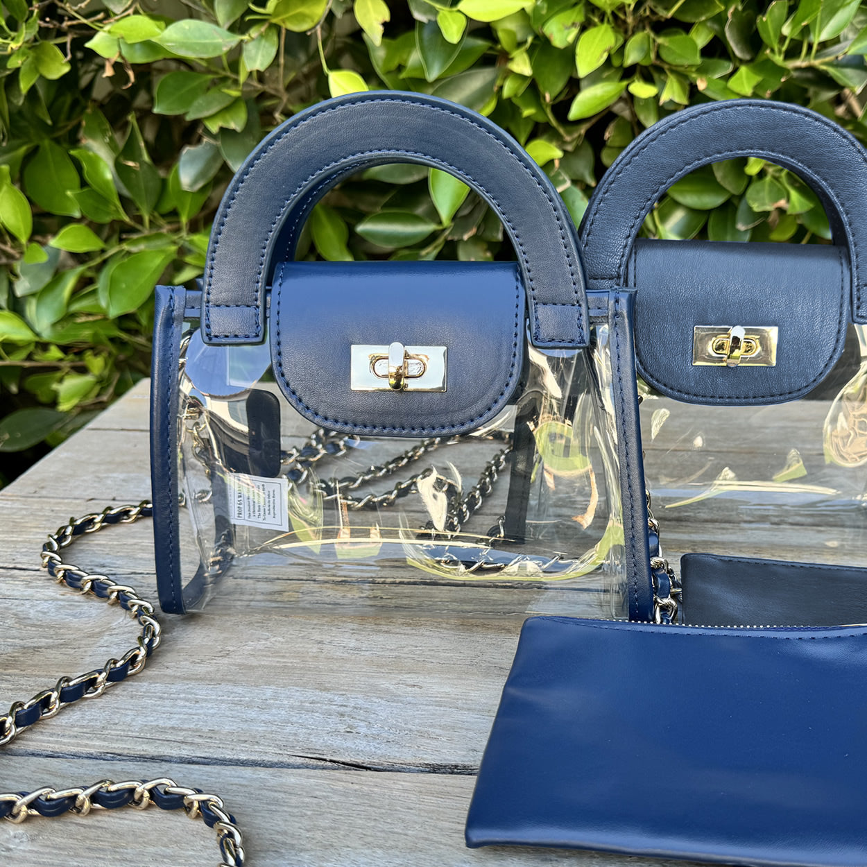 Clear, stadium-approved fashion purse with navy faux-leather trim and a gold chain
