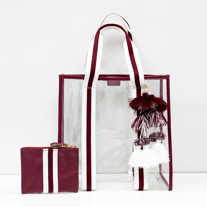 Clear, stadium-approved tote bag with sporty maroon and white striped straps